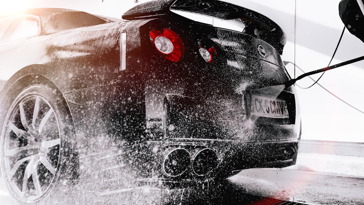Automotive technician working on black car at ABBA Auto Dubai